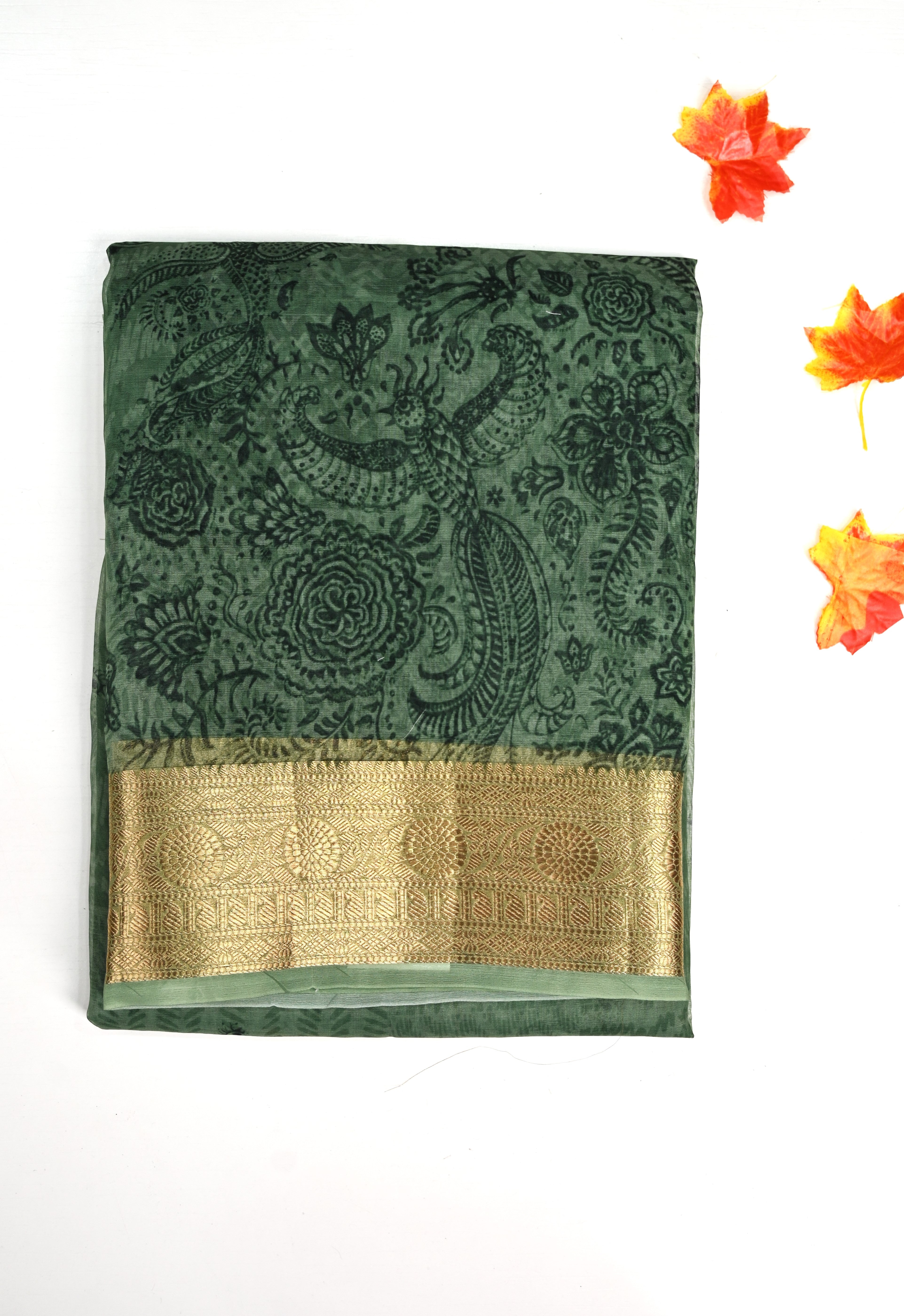 Organza Saree green color with allover prints, small gold zari border, short pallu and plain blouse