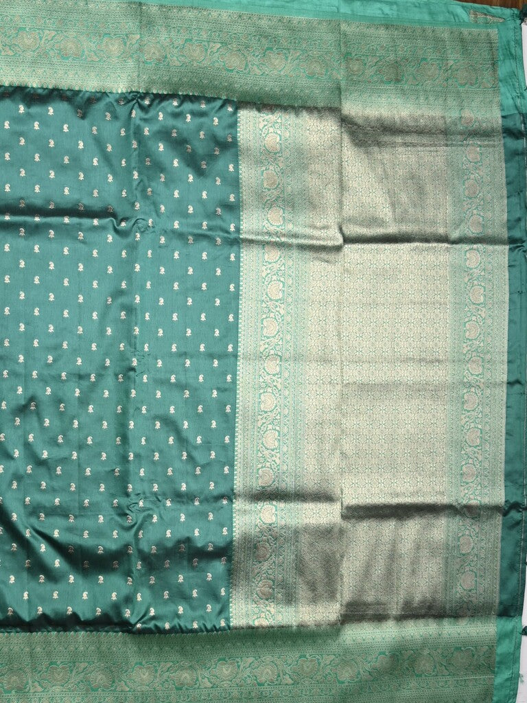 Dupion fancy saree peacock green color allover zari motifs & zari border with rich pallu and plain blouse