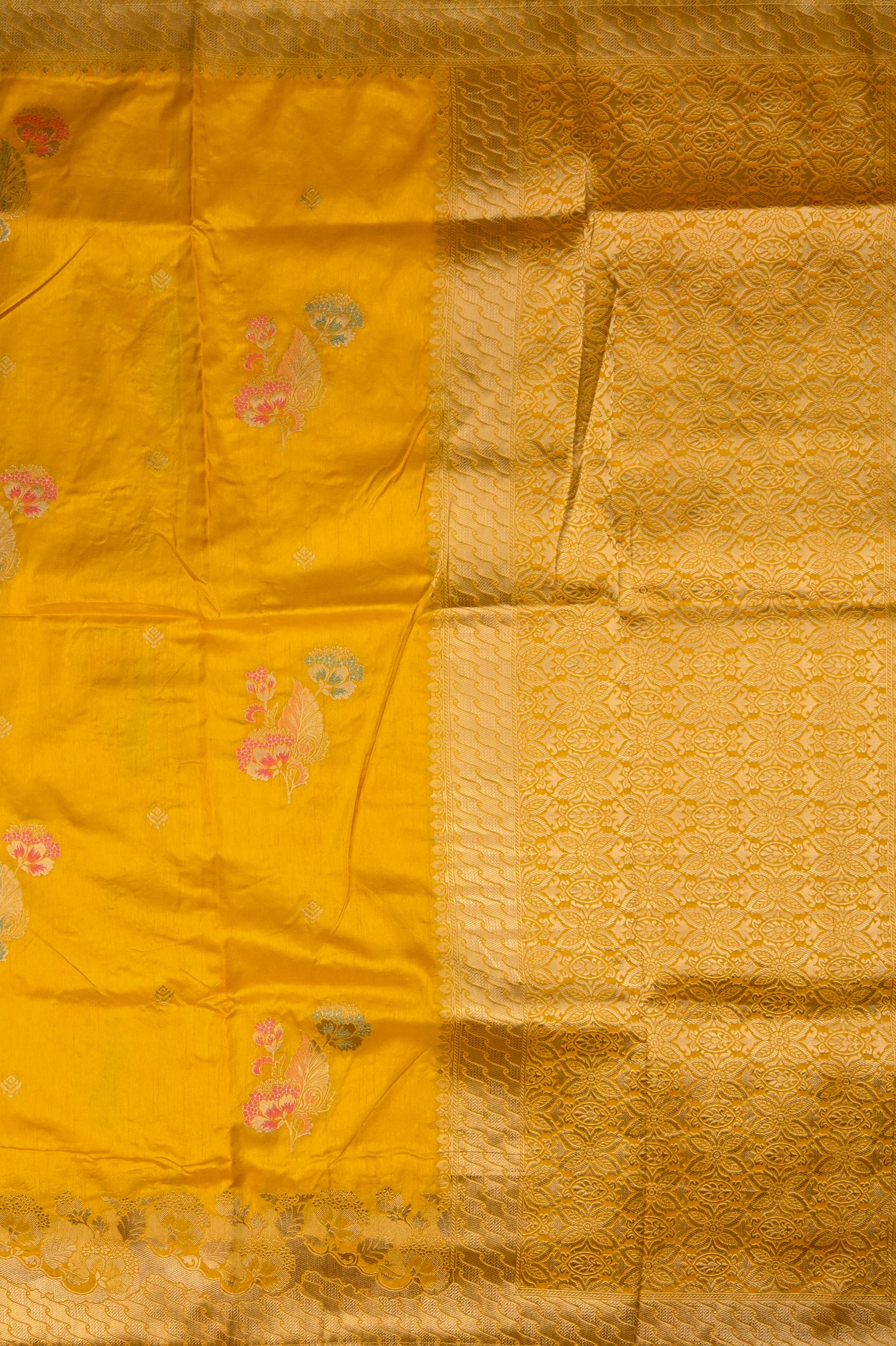 Dola silk saree dark yellow color with allover meenakari motives, rich pallu, small zari border and running plain blouse.