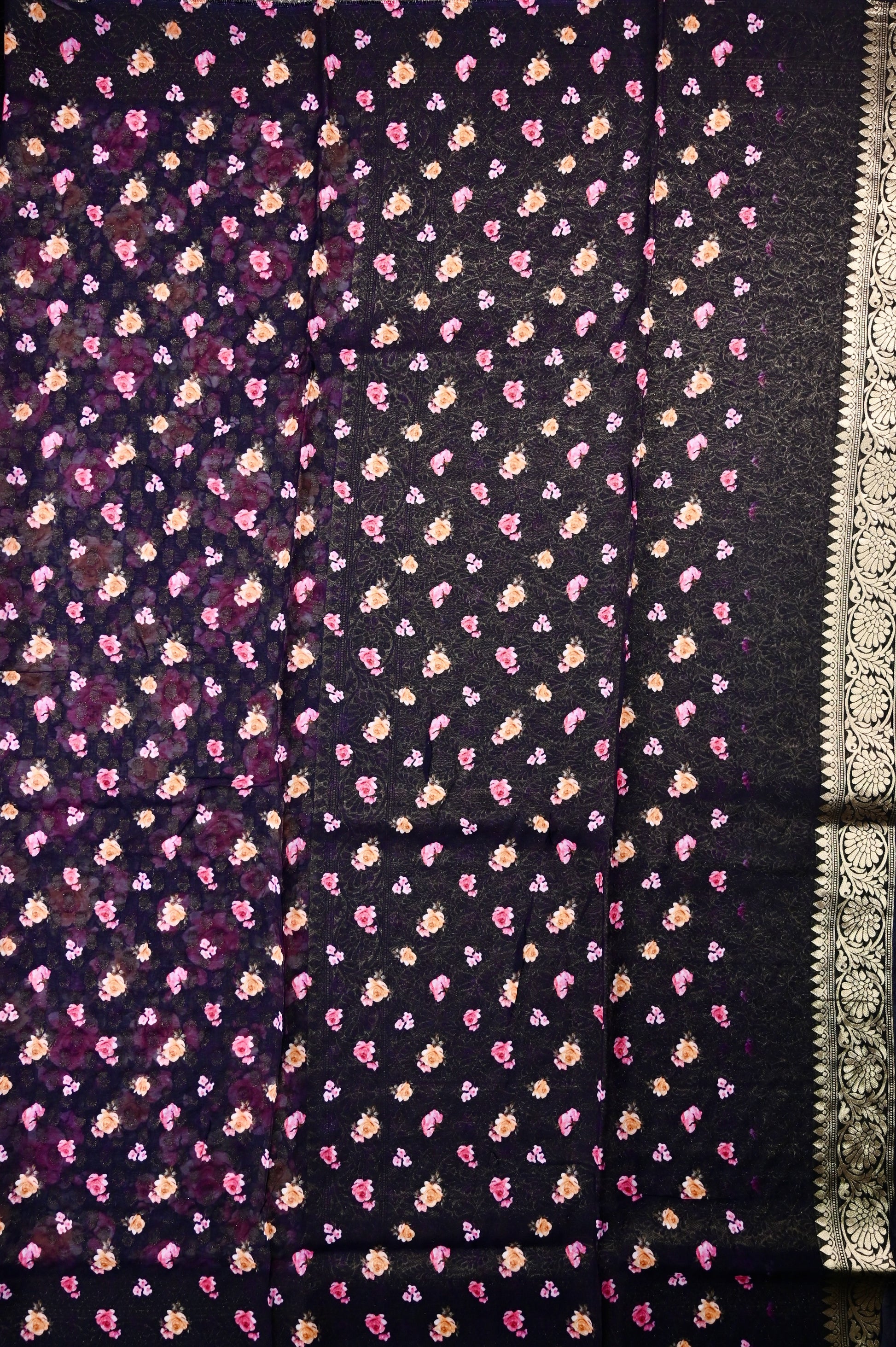 Georgette saree black color with allover zari motives and floral prints, small zari border, short pallu and printed blouse.