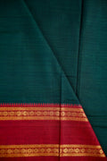 Narayanpet cotton saree bottle green color with contrast zari gap border, short pallu and plain blouse.