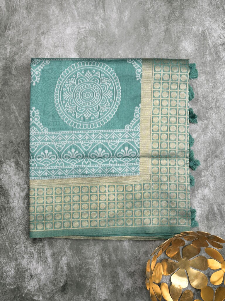 Dupion fancy saree peacock blue color allover prints & zari border with rich pallu and attached plain blouse