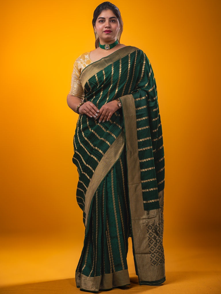 Crape fancy saree dark green color allover zari weaves & zari border with zari pallu and plain blouse