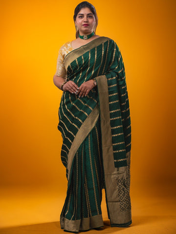 Crape fancy saree dark green color allover zari weaves & zari border with zari pallu and plain blouse