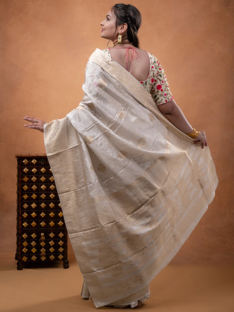Dola tissue fancy saree white color allover zari motifs & zari border with rich pallu and plain self blouse