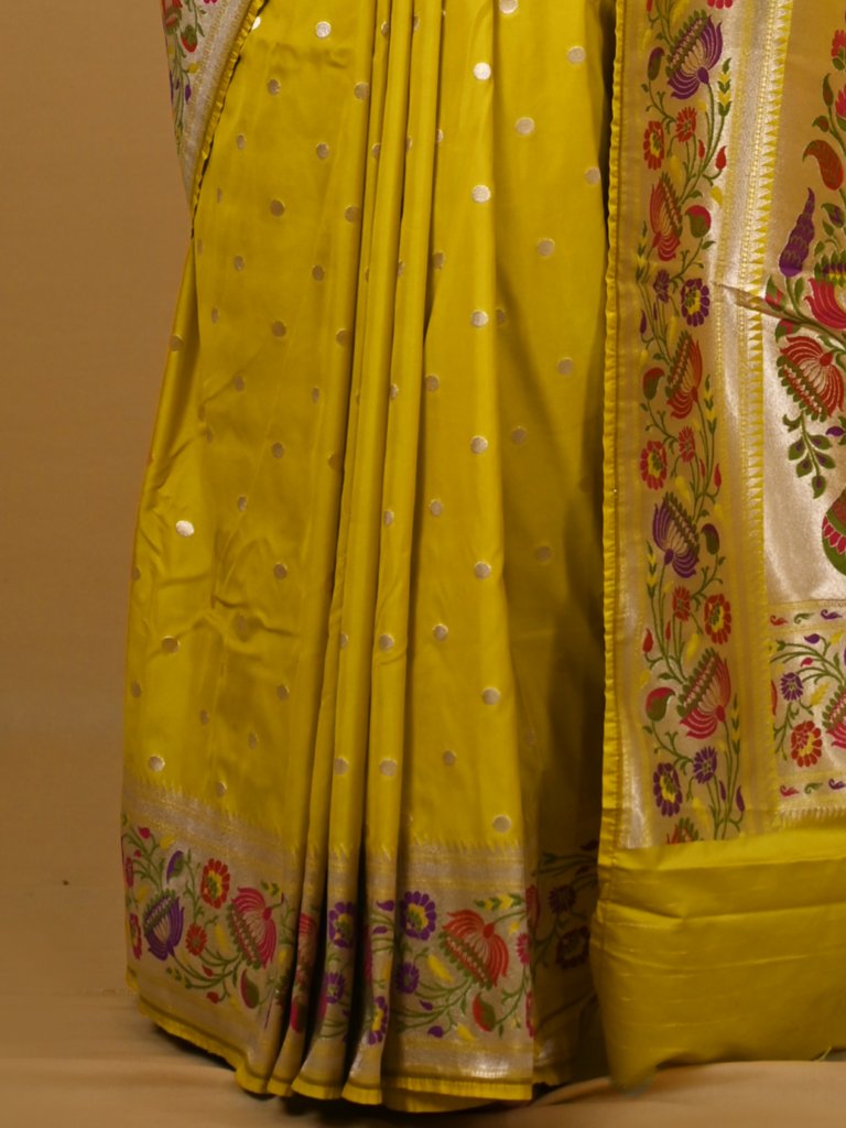 Banaras pattu fancy saree in yellow color allover zari motifs and paithani border paired with plain blouse