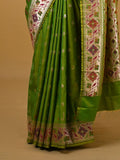 Banaras pattu fancy saree in parrot green color allover zari motifs and paithani border paired with plain blouse