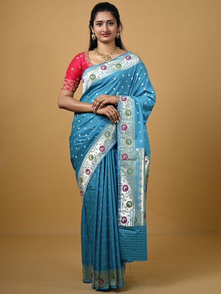Banaras pattu fancy saree in sky blue color allover zari motifs and paithani border paired with plain blouse