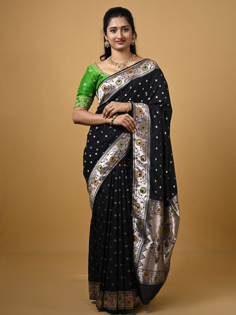 Banaras pattu fancy saree in black color allover zari motifs and paithani border paired with plain blouse