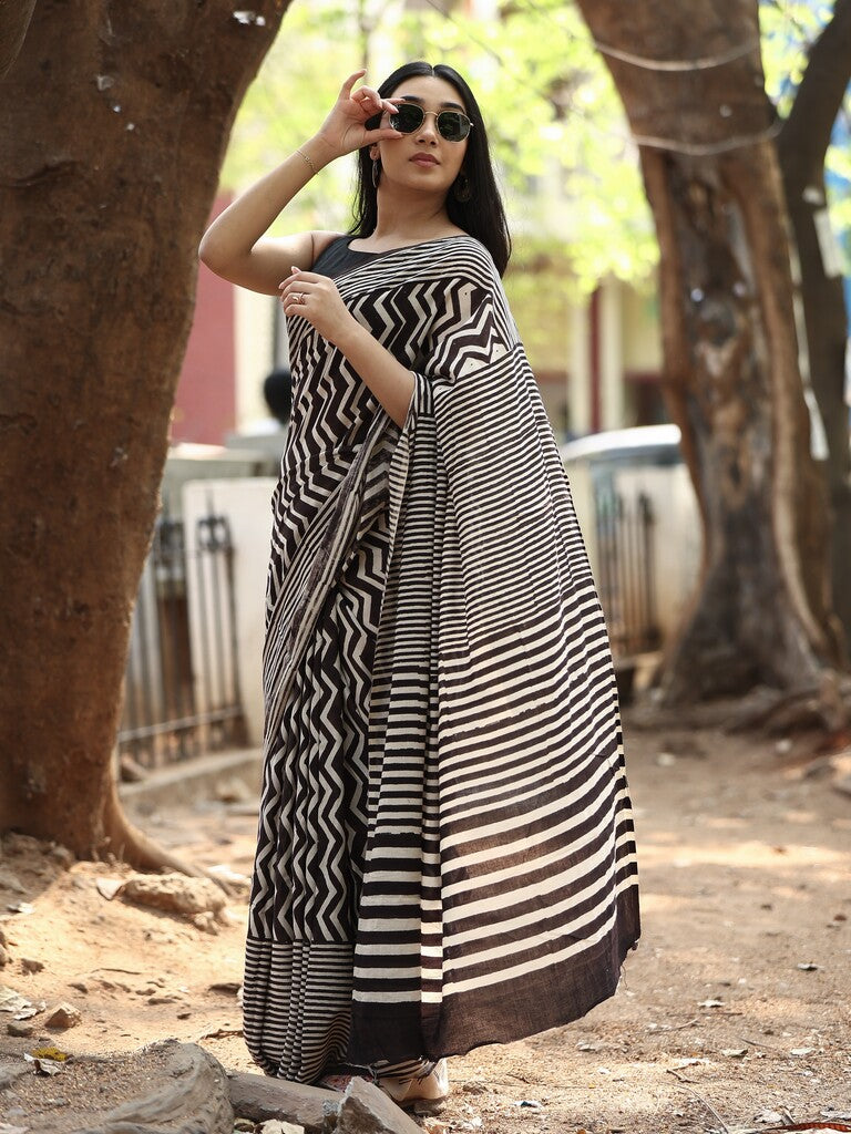 Maheswari fancy saree in black and white color with printed pallu and attached blouse