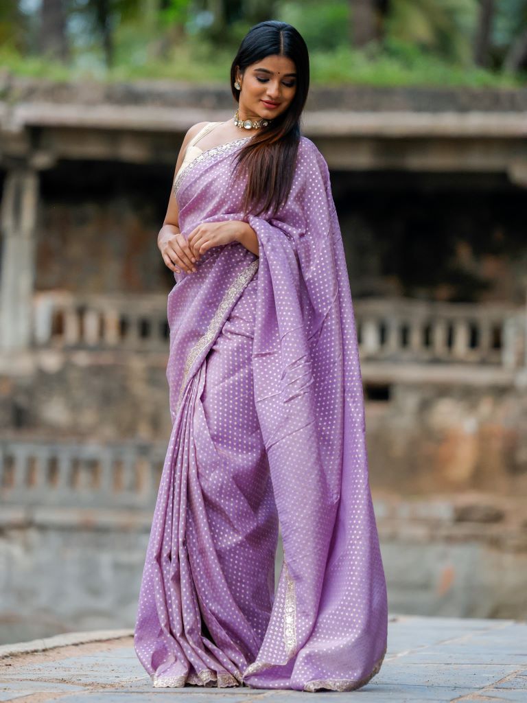 Dola tissue fancy saree lavender color allover zari motifs & embroidery cutwork border with running pallu and attached blouse