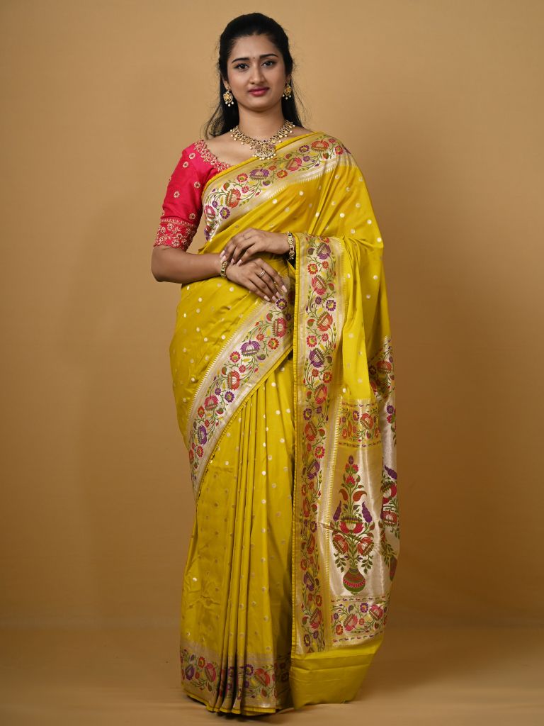 Banaras pattu fancy saree in yellow color allover zari motifs and paithani border paired with plain blouse