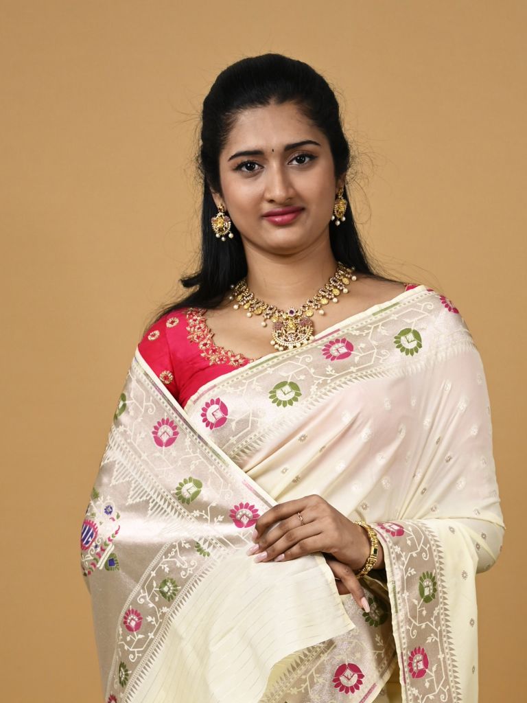 Banaras pattu fancy saree in cream color allover zari motifs and paithani border paired with plain blouse