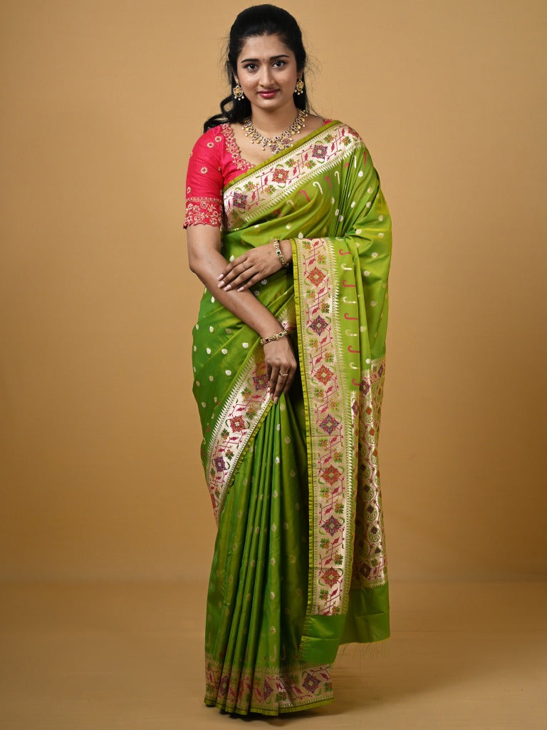 Banaras pattu fancy saree in parrot green color allover zari motifs and paithani border paired with plain blouse