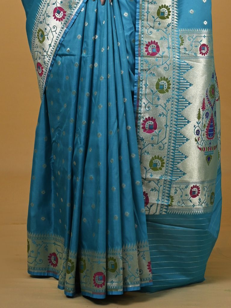 Banaras pattu fancy saree in sky blue color allover zari motifs and paithani border paired with plain blouse
