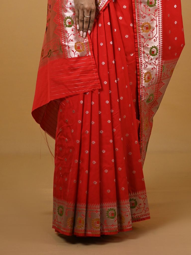 Banaras pattu fancy saree in red color allover zari motifs and paithani border paired with plain blouse