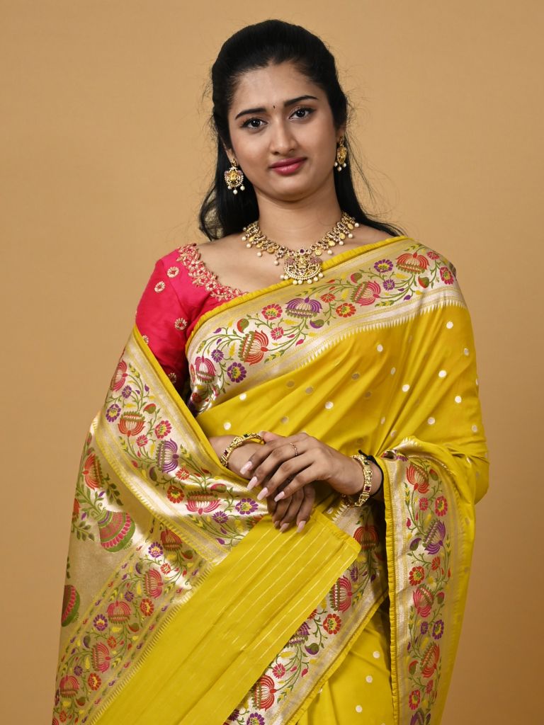 Banaras pattu fancy saree in yellow color allover zari motifs and paithani border paired with plain blouse