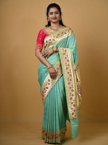 Banaras pattu fancy saree in light blue color allover zari motifs and paithani border paired with plain blouse