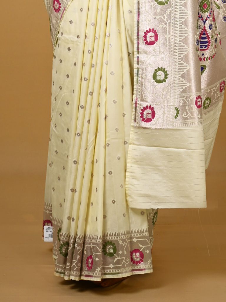 Banaras pattu fancy saree in cream color allover zari motifs and paithani border paired with plain blouse
