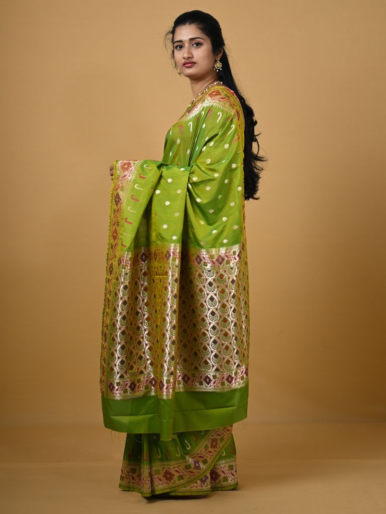 Banaras pattu fancy saree in parrot green color allover zari motifs and paithani border paired with plain blouse