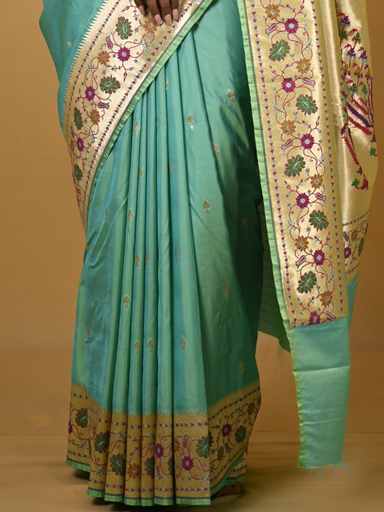 Banaras pattu fancy saree in light blue color allover zari motifs and paithani border paired with plain blouse