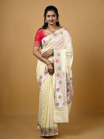 Banaras pattu fancy saree in cream color allover zari motifs and paithani border paired with plain blouse
