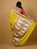 Banaras pattu fancy saree in yellow color allover zari motifs and paithani border paired with plain blouse