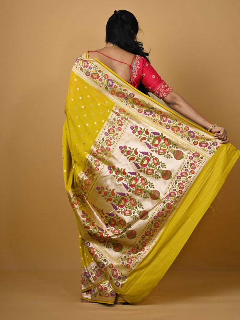 Banaras pattu fancy saree in yellow color allover zari motifs and paithani border paired with plain blouse
