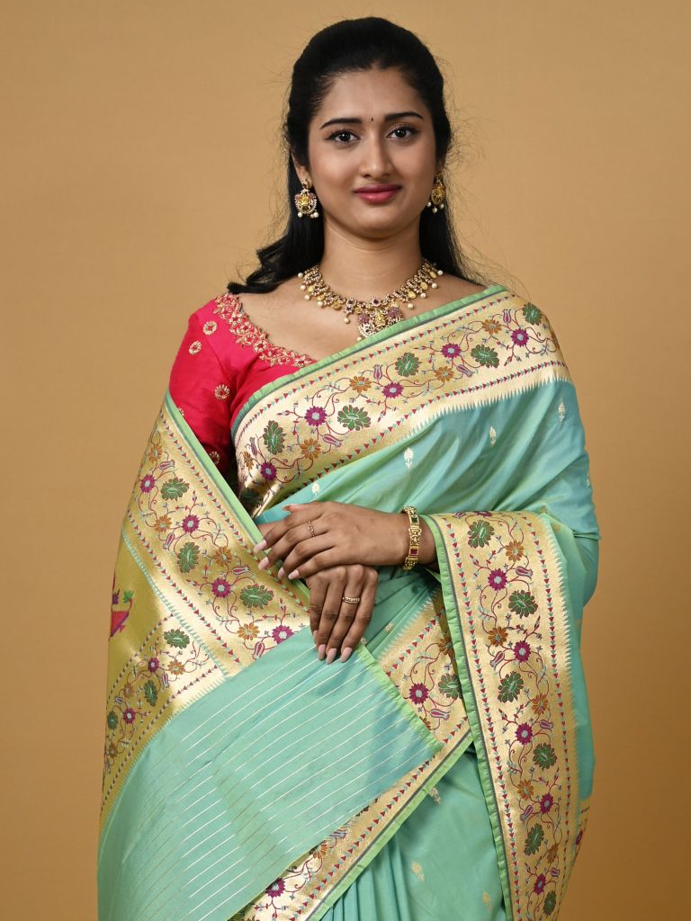 Banaras pattu fancy saree in light blue color allover zari motifs and paithani border paired with plain blouse