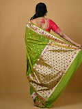 Banaras pattu fancy saree in parrot green color allover zari motifs and paithani border paired with plain blouse