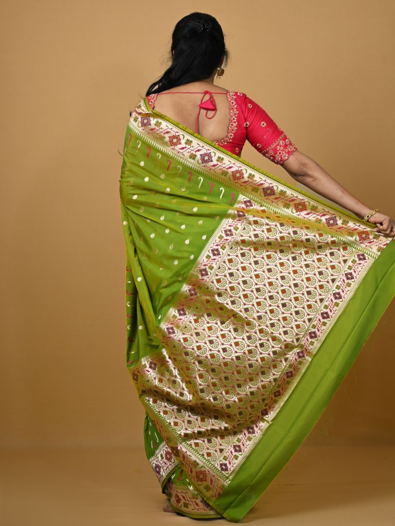 Banaras pattu fancy saree in parrot green color allover zari motifs and paithani border paired with plain blouse