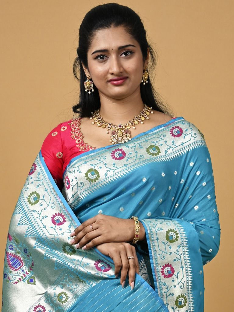 Banaras pattu fancy saree in sky blue color allover zari motifs and paithani border paired with plain blouse