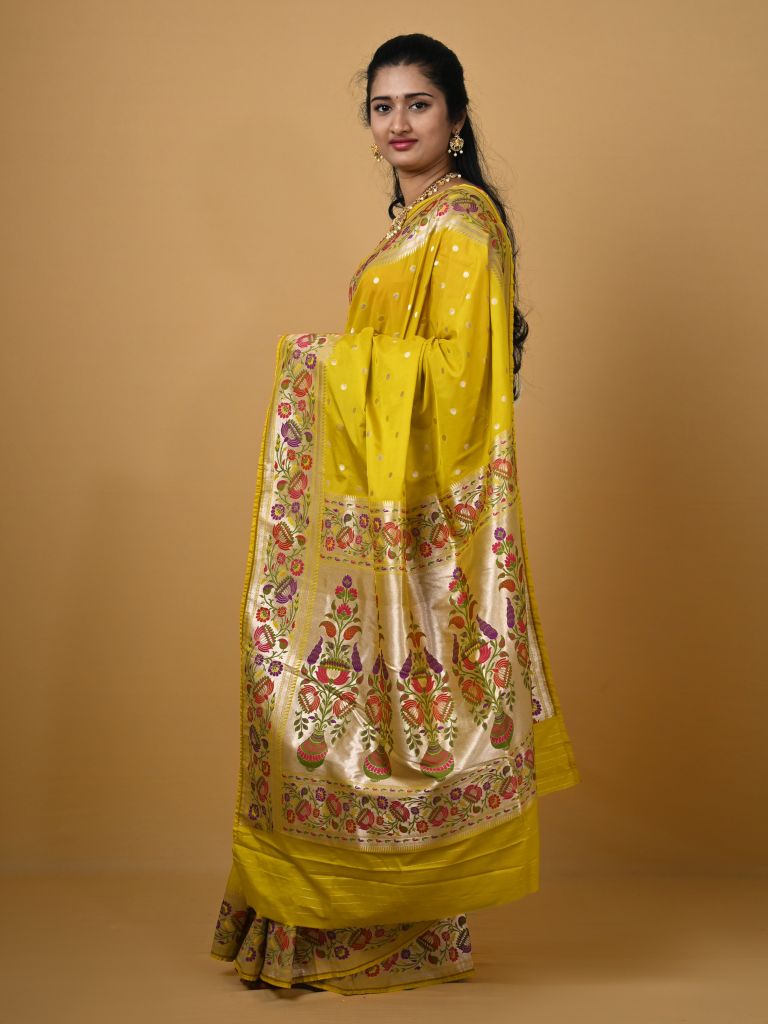 Banaras pattu fancy saree in yellow color allover zari motifs and paithani border paired with plain blouse
