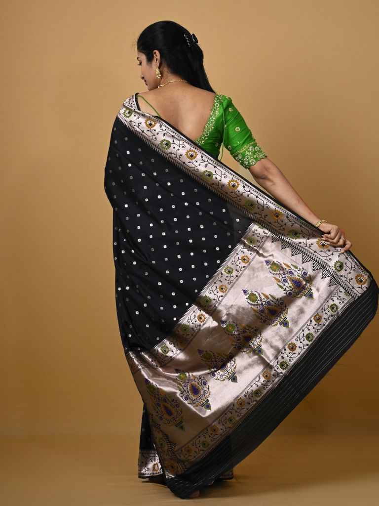 Banaras pattu fancy saree in black color allover zari motifs and paithani border paired with plain blouse