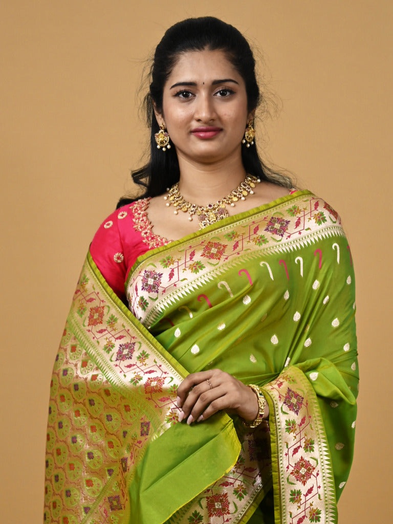 Banaras pattu fancy saree in parrot green color allover zari motifs and paithani border paired with plain blouse
