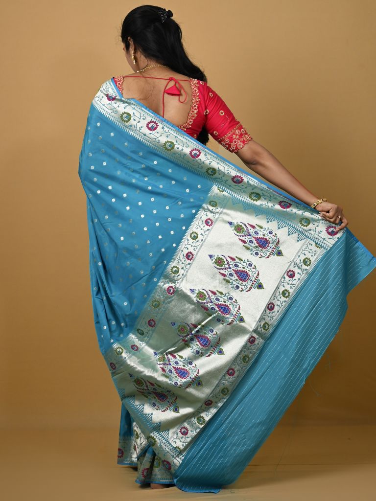 Banaras pattu fancy saree in sky blue color allover zari motifs and paithani border paired with plain blouse