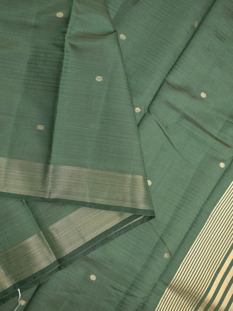Dupion fancy saree bottle green color allover zari motifs & zari border with short pallu and attached blouse