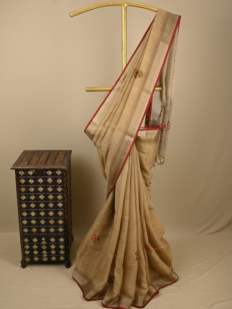 Lenin tissue embroidered fancy saree in light beige color with embroidery pallu and matching blouse