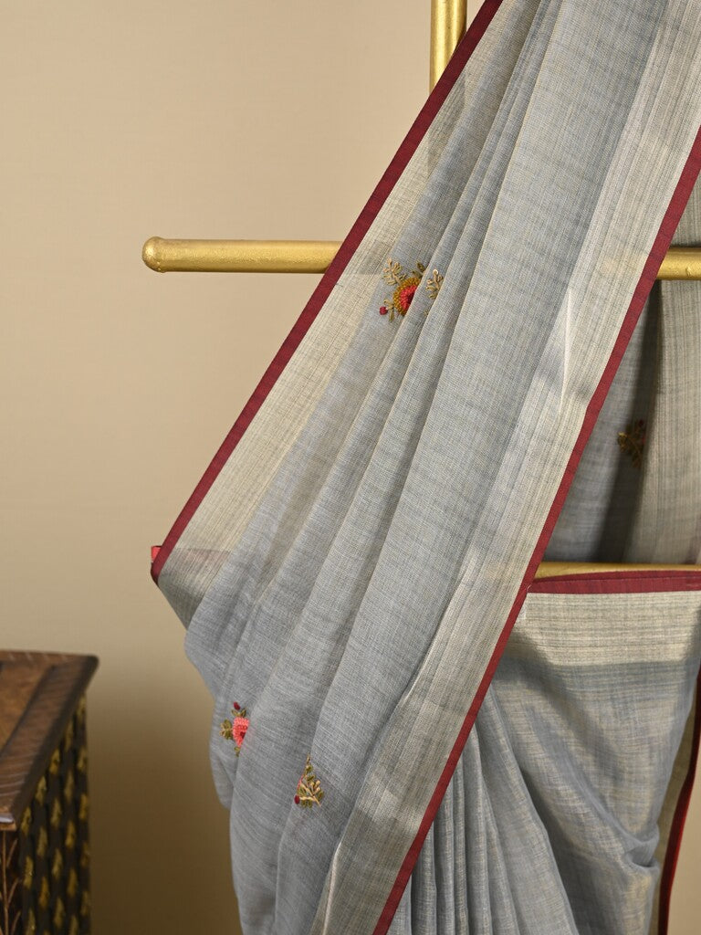 Lenin tissue embroidered fancy saree in light grey color with embroidery pallu and matching blouse