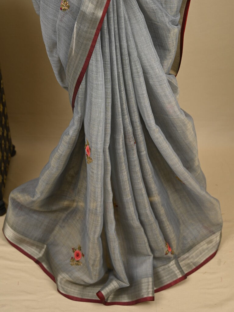 Lenin tissue embroidered fancy saree in light grey color with embroidery pallu and matching blouse