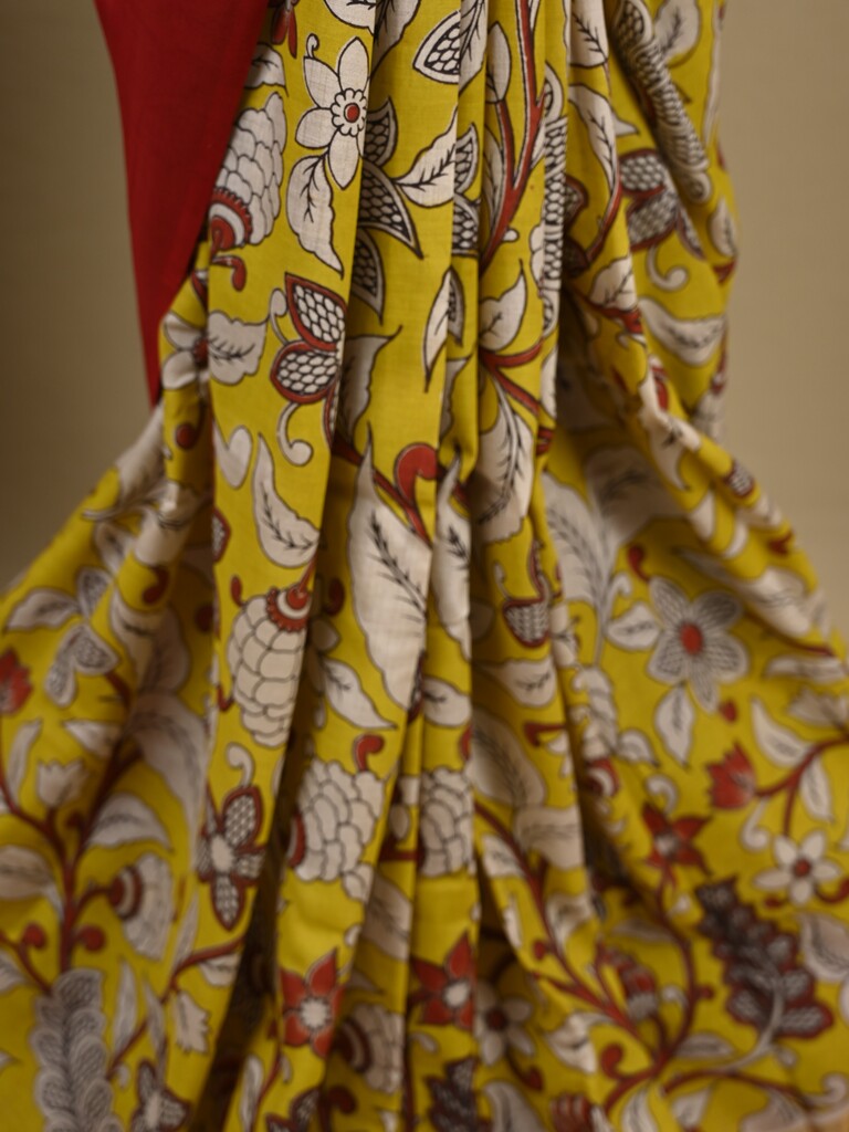 Kalamkari silk saree in yellow, featuring a contrast color border and plain matching blouse