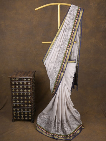 Maheshwari fancy saree in white color with allover prints & zari border with short pallu and contrast blouse