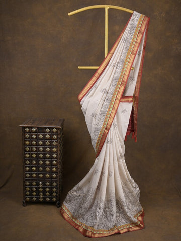 Maheshwari fancy saree in white color with allover prints & zari border with short pallu and contrast blouse