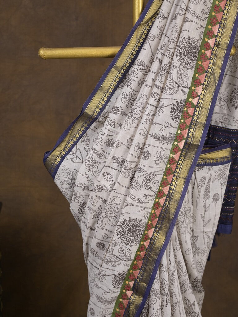 Maheshwari fancy saree in white color with allover prints & zari border with short pallu and contrast blouse