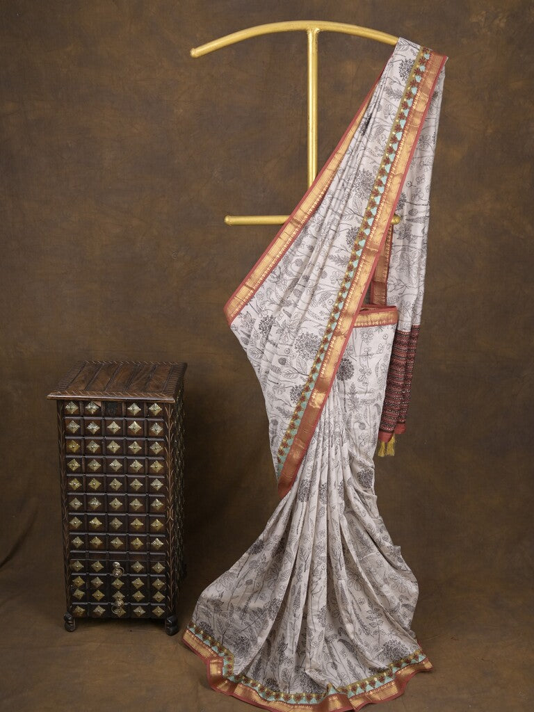 Maheshwari fancy saree in white color with allover prints & zari border with short pallu and contrast blouse