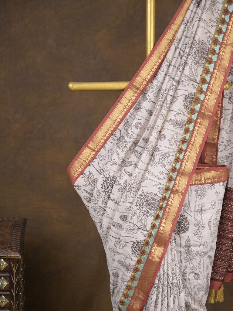 Maheshwari fancy saree in white color with allover prints & zari border with short pallu and contrast blouse