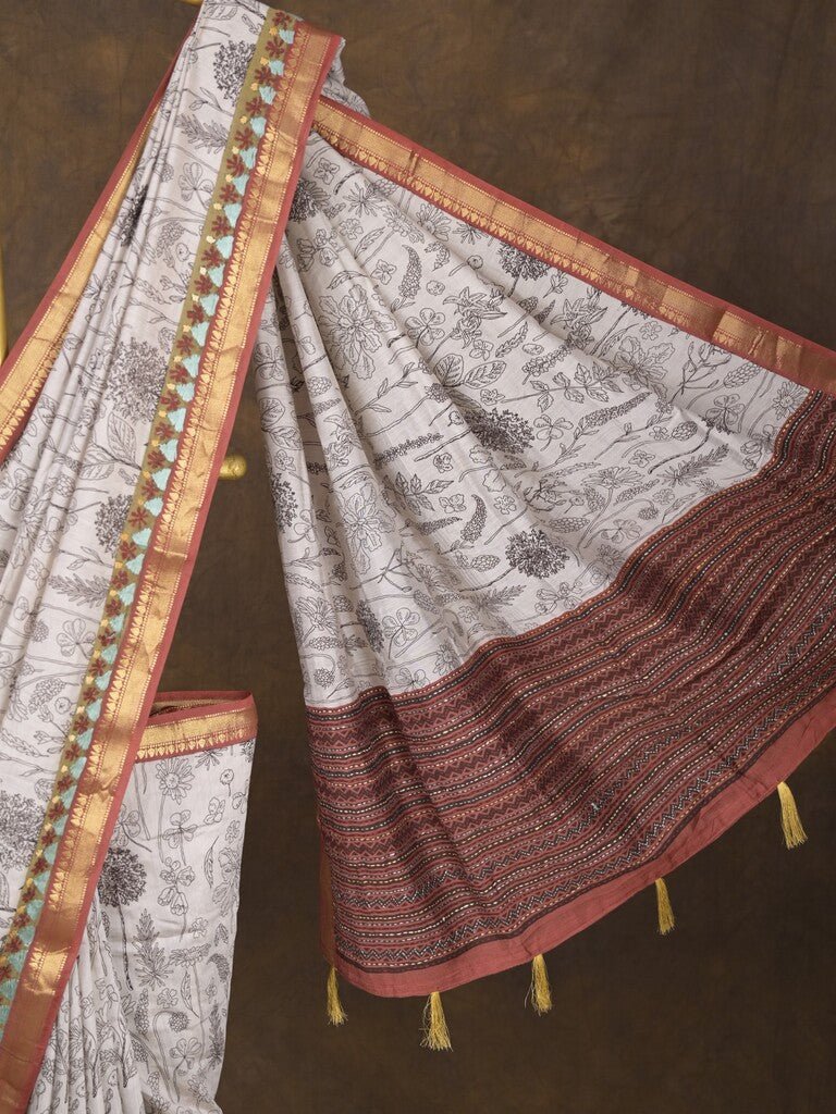 Maheshwari fancy saree in white color with allover prints & zari border with short pallu and contrast blouse