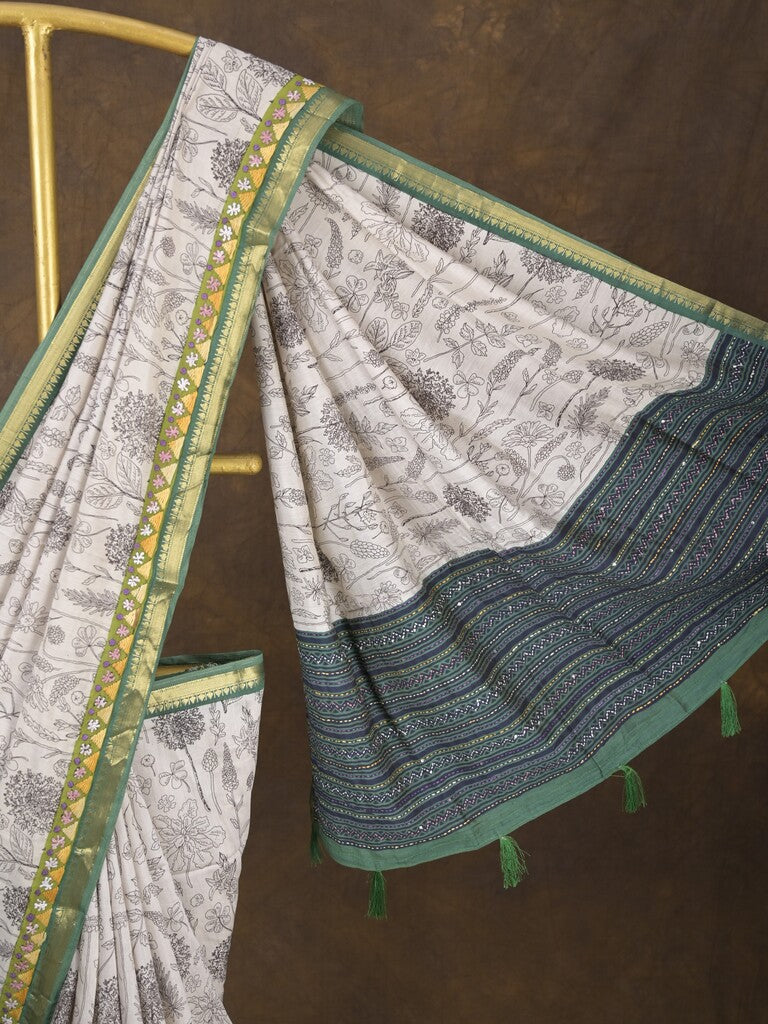 Maheshwari fancy saree in white color with allover prints & zari border with short pallu and contrast blouse