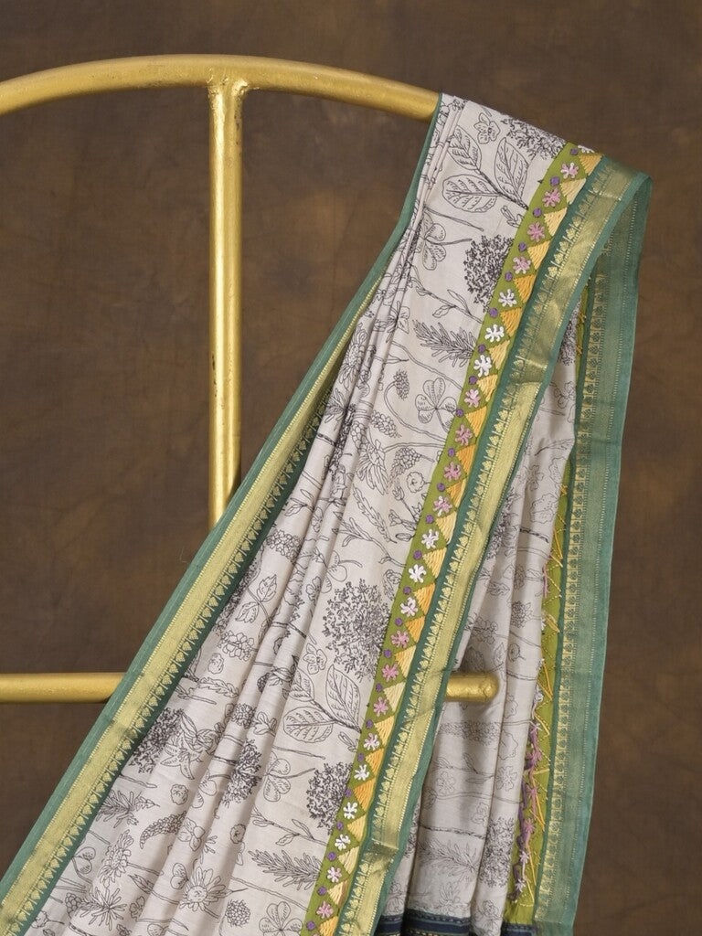 Maheshwari fancy saree in white color with allover prints & zari border with short pallu and contrast blouse