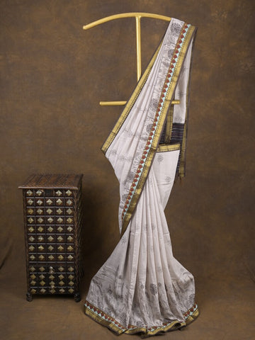 Maheshwari fancy saree in white color with allover prints & zari border with short pallu and contrast blouse